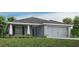 One-story home with gray siding, shutters, and a two-car garage at 1040 Aruba Ave, Mulberry, FL 33860