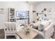 Living room with light-colored furniture, built-in shelving, and large TV at 1040 Aruba Ave, Mulberry, FL 33860