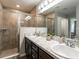 Modern bathroom with double vanity, large shower, and stylish finishes at 1048 Mountain Flower, Davenport, FL 33837