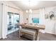 Dining area with wooden table, bench seating, and sliding glass doors at 10747 Sw 76Th Ct, Ocala, FL 34480