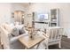 Spacious living room featuring light-colored furniture and wood-look floors at 10747 Sw 76Th Ct, Ocala, FL 34480