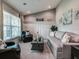 Living area with gray walls, wood-look floors, and built-in shelving at 10763 Sw 76Th Ct, Ocala, FL 34480