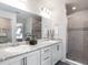 Modern bathroom with double vanity, large mirror, and walk-in shower at 1135 Aruba Ave, Mulberry, FL 33860