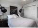 Stylish bedroom with guitar-themed wall art and striped bedding at 1135 Aruba Ave, Mulberry, FL 33860