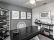 Home office with a large desk, built-in shelving, and inspirational decor at 1135 Aruba Ave, Mulberry, FL 33860