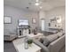 Living room features gray walls, white furniture, and a large TV at 1135 Aruba Ave, Mulberry, FL 33860