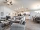 Open concept living room with gray sofas and hardwood floors at 1148 Aruba Ave, Mulberry, FL 33860