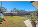 Expansive backyard featuring a play set, lush lawn, and a screened-in pool area at 1325 Fairlee St, Lakeland, FL 33813