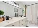 The bathroom has double sinks, a large mirror, and a white shower curtain with black fixtures at 1325 Fairlee St, Lakeland, FL 33813