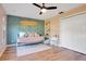 The bedroom features a daybed, light pink walls, a ceiling fan, and a large white closet at 1325 Fairlee St, Lakeland, FL 33813