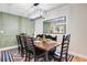 Dining room features a wooden table with black chairs, decorative rug, modern light fixture, and wall mirror at 1325 Fairlee St, Lakeland, FL 33813