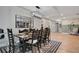 A dining room with a wooden table, black chairs, a decorative rug, and a modern light fixture at 1325 Fairlee St, Lakeland, FL 33813