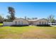 Inviting single-Gathering home with a manicured front yard, arched windows and well-kept landscaping at 1325 Fairlee St, Lakeland, FL 33813