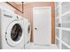 The laundry room contains a front-load washing machine and dryer on hexagon tile flooring at 1325 Fairlee St, Lakeland, FL 33813