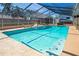 Inviting pool with clear blue water, a modern enclosure, and a relaxing sun lounger at 1325 Fairlee St, Lakeland, FL 33813