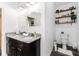 Bathroom with double sinks, granite countertops, shelves, and a toilet at 1495 Davis Ave, Bartow, FL 33830