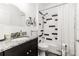 Bathroom with a black and white tiled shower and black vanity at 1495 Davis Ave, Bartow, FL 33830