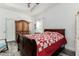 Comfortable bedroom with wood-look floors, a decorative quilt, and wooden furnishings at 1495 Davis Ave, Bartow, FL 33830