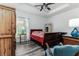 Charming bedroom with wood-look flooring and a rustic wooden armoire at 1495 Davis Ave, Bartow, FL 33830