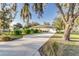 Long concrete driveway leading to the attached garage, with a spacious yard at 1495 Davis Ave, Bartow, FL 33830