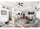 Spacious living room flows into the open kitchen and dining area, featuring wood-look flooring and a modern design at 1495 Davis Ave, Bartow, FL 33830