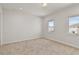 Well-lit bedroom featuring carpet floors and two windows at 171 Golden Noble St, Kissimmee, FL 34747