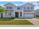 Two-story house with gray siding, a three-car garage, and a well-manicured lawn at 171 Golden Noble St, Kissimmee, FL 34747