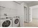 Bright laundry room with washer, dryer, and shelving at 171 Golden Noble St, Kissimmee, FL 34747