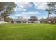 Expansive backyard featuring a screened-in patio, lush green lawn, and a storage shed at 20 N Lake Idylwild Dr, Winter Haven, FL 33881