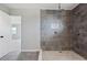 The bathroom features a modern shower with tiled walls and stone base at 20 N Lake Idylwild Dr, Winter Haven, FL 33881