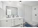 Bright bathroom featuring a double sink vanity, framed mirror, and tiled shower at 20 N Lake Idylwild Dr, Winter Haven, FL 33881