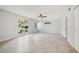 Bright bedroom with tile flooring, ceiling fan, and large windows showcasing a green yard at 20 N Lake Idylwild Dr, Winter Haven, FL 33881