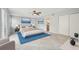 Bright bedroom featuring a ceiling fan, a large window, and a blue accent rug at 20 N Lake Idylwild Dr, Winter Haven, FL 33881