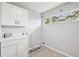 Convenient laundry room area with plenty of storage and natural light at 20 N Lake Idylwild Dr, Winter Haven, FL 33881