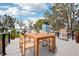 Outdoor dining area on a patio with a wooden table, chairs, a grill, and scenic views of the lake and backyard at 20 N Lake Idylwild Dr, Winter Haven, FL 33881