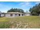 Large backyard with grassy area and partial view of the house at 2004 Varner Cir, Winter Haven, FL 33884