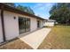 Home's backyard with a patio and sliding glass doors at 2004 Varner Cir, Winter Haven, FL 33884