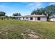 Large backyard with grassy area and partial view of the house at 2004 Varner Cir, Winter Haven, FL 33884