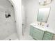 Elegant bathroom with marble shower, green vanity, and gold fixtures at 2016 Seminole Trl, Lakeland, FL 33803