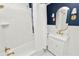 Bathroom with white scalloped tile, gold fixtures, and a white vanity at 2016 Seminole Trl, Lakeland, FL 33803