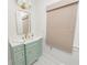 Modern bathroom with mint green vanity, gold fixtures and marble flooring at 2016 Seminole Trl, Lakeland, FL 33803