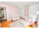 Bright Bedroom with pink walls, white crib, and ample closet space at 2016 Seminole Trl, Lakeland, FL 33803