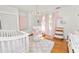 Charming Bedroom featuring pink gingham curtains and a white crib at 2016 Seminole Trl, Lakeland, FL 33803