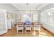 Spacious dining room featuring hardwood floors, a wooden table, and white chairs at 2016 Seminole Trl, Lakeland, FL 33803