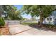 Wide driveway with a privacy gate and mature landscaping adding to the curb appeal at 2016 Seminole Trl, Lakeland, FL 33803