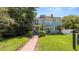 Charming two-story home with a brick walkway, lush green lawn, and professional signage at 2016 Seminole Trl, Lakeland, FL 33803