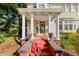 Front porch with columns, red brick steps, and potted plants at 2016 Seminole Trl, Lakeland, FL 33803