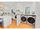 Kitchen with built-in washer and dryer, and white cabinetry at 2016 Seminole Trl, Lakeland, FL 33803