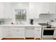 White kitchen with marble countertops, farmhouse sink, and stainless steel appliances at 2016 Seminole Trl, Lakeland, FL 33803