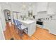 Bright white kitchen with marble countertops, stainless steel appliances, and hardwood floors at 2016 Seminole Trl, Lakeland, FL 33803